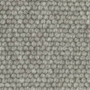 A close up of a gray rug with a knitted pattern.