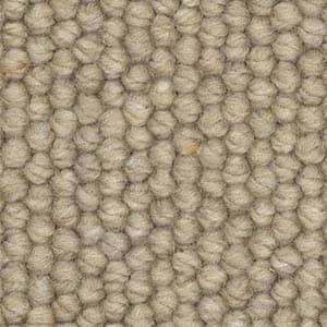 A close up of a carpet with a knitted pattern.