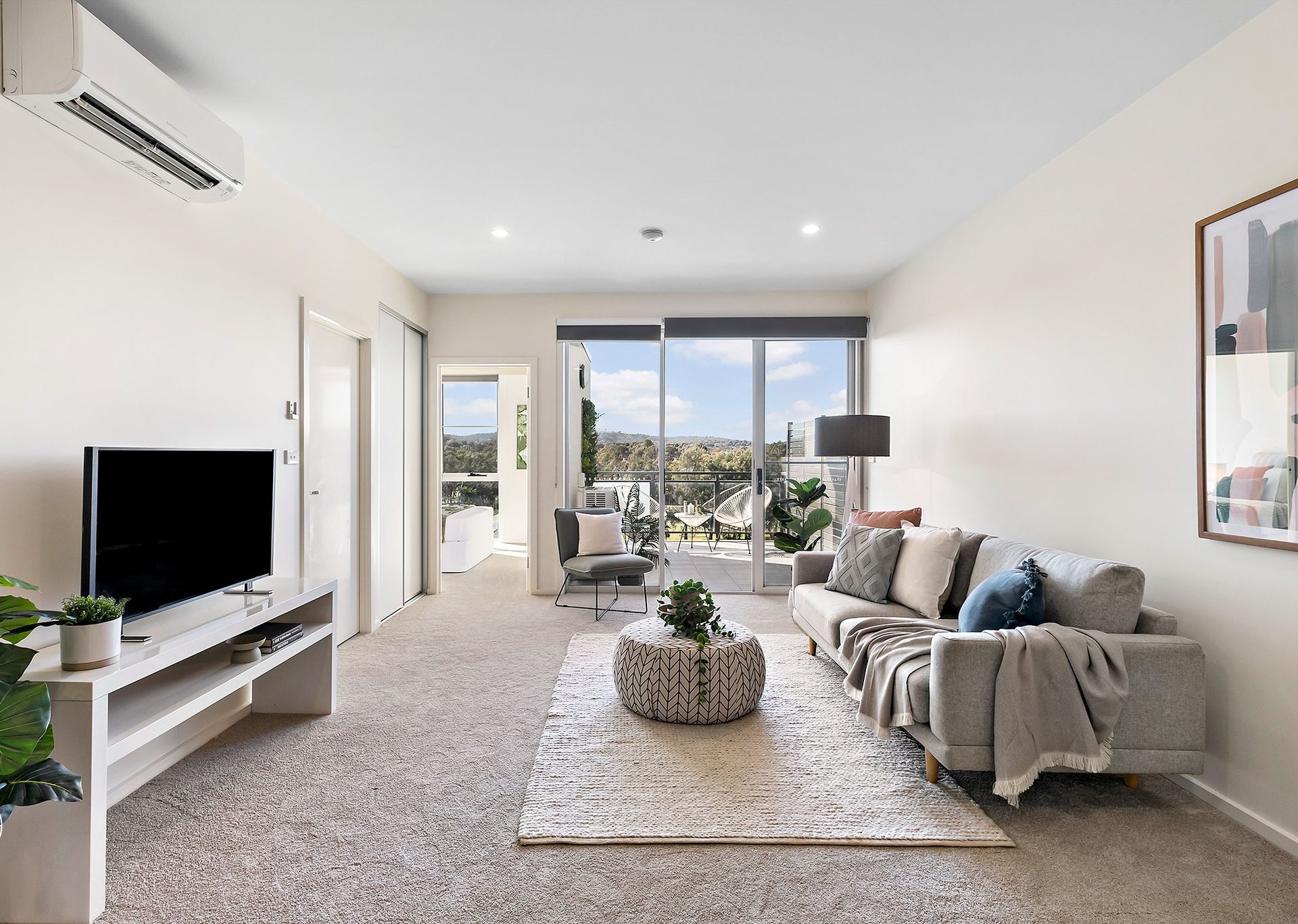 A living room with a couch and a flat screen tv