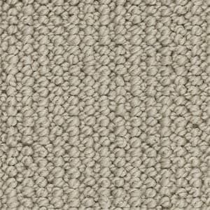 A close up of a beige carpet texture.
