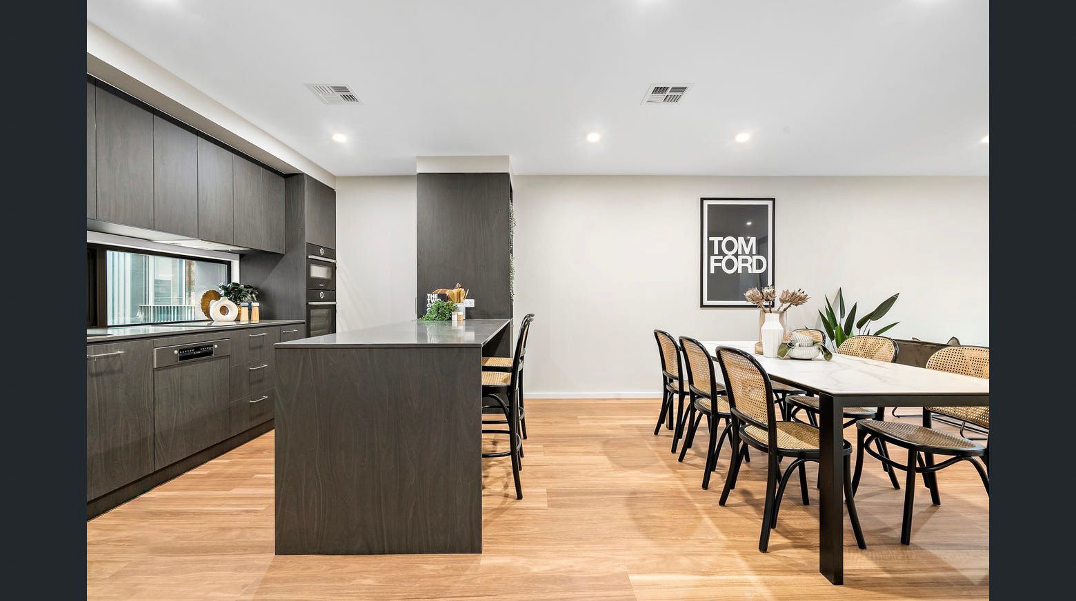 A kitchen and dining room in a house with a table and chairs.