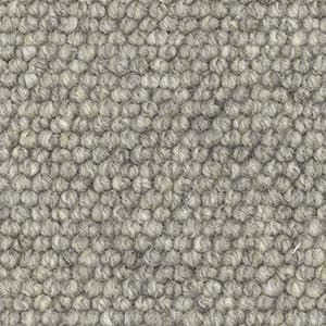 A close up of a gray carpet with a polka dot pattern.