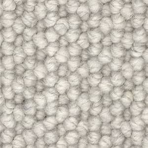 A close up of a white carpet with a knitted pattern.