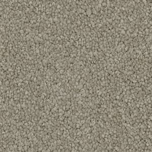 A close up of a carpet with a lot of small stones on it.