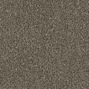 A close up of a carpet with a lot of small stones on it.