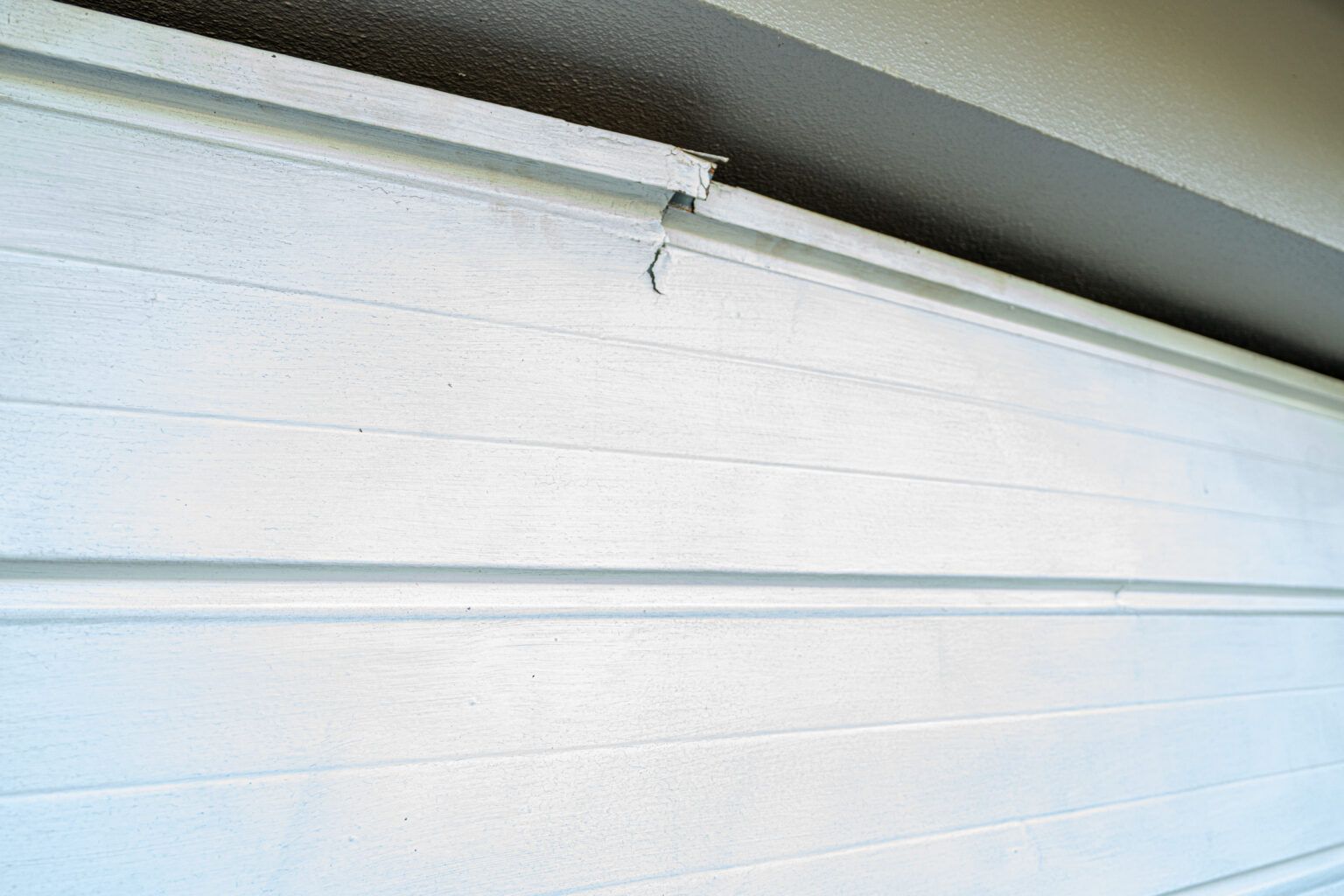 Cracked white garage door Cracked white garage door