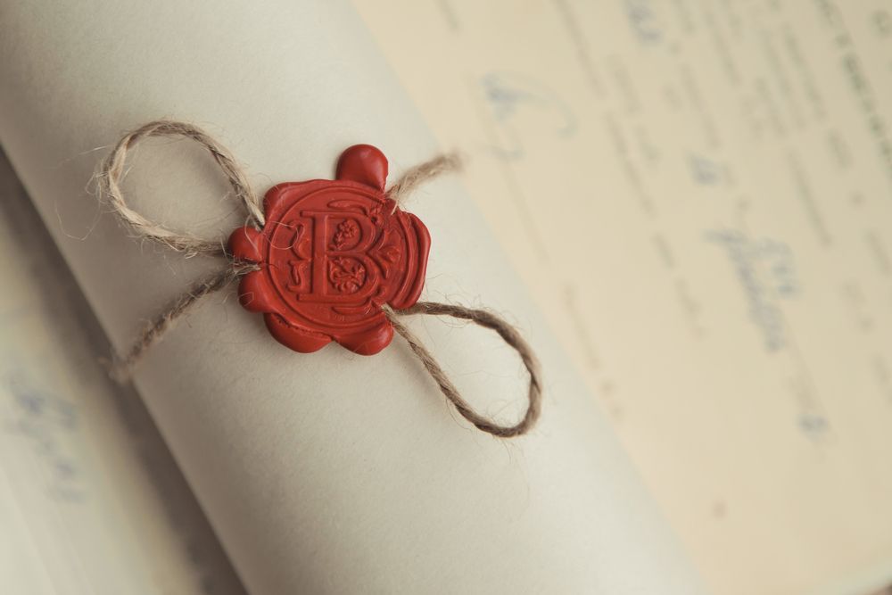 A piece of paper with a red wax seal on it