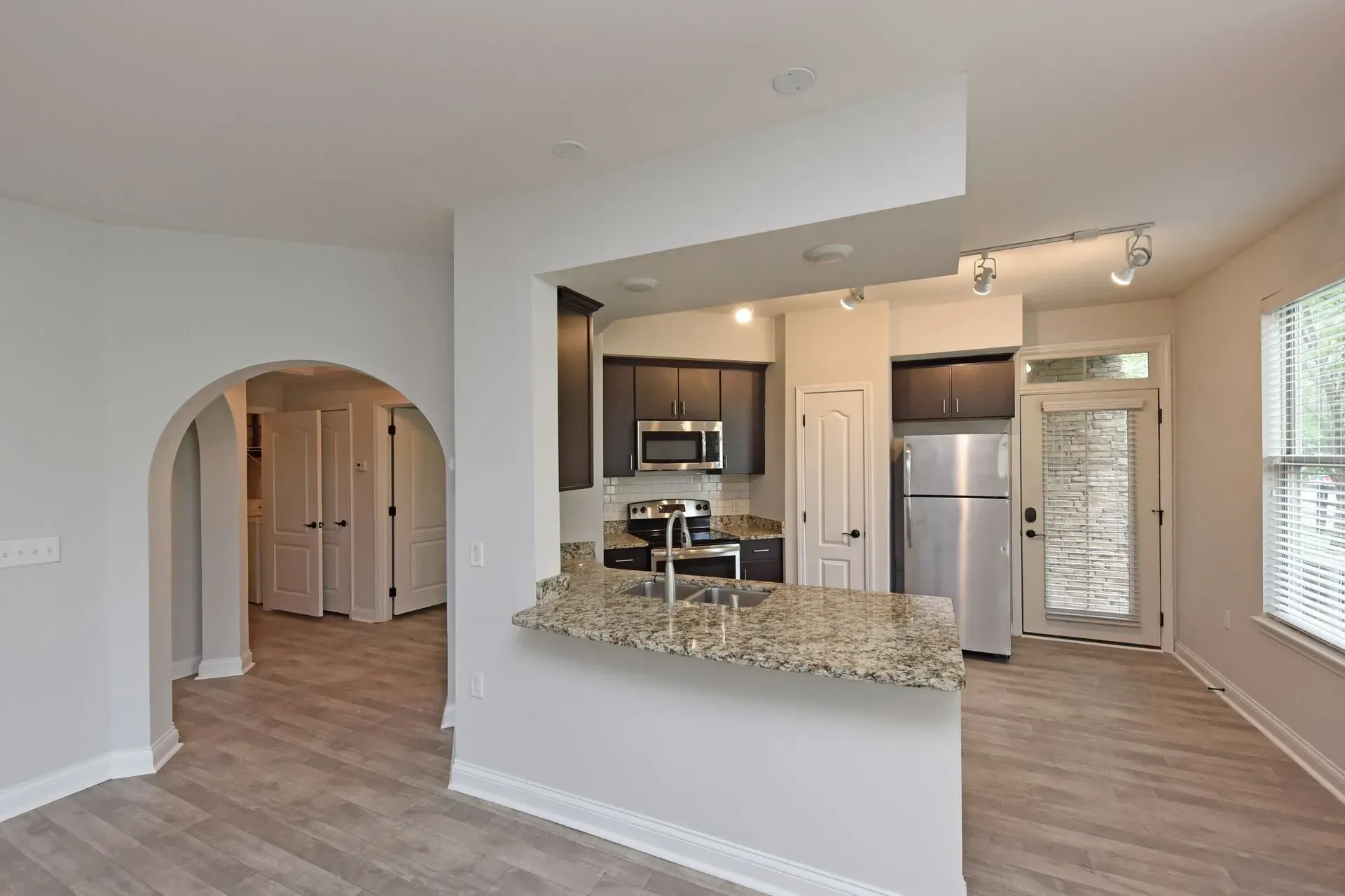 Modern kitchen with granite countertops and stainless steel appliances.