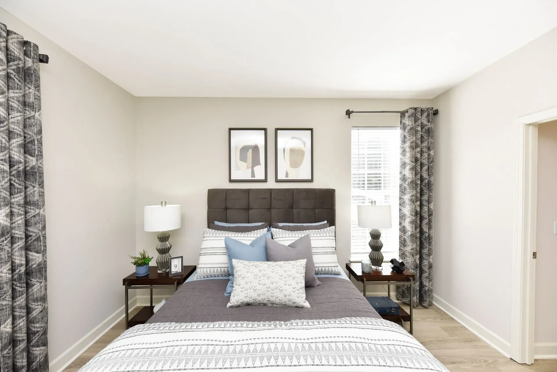 Bedroom with a queen-size bed, nightstands, and curtains.