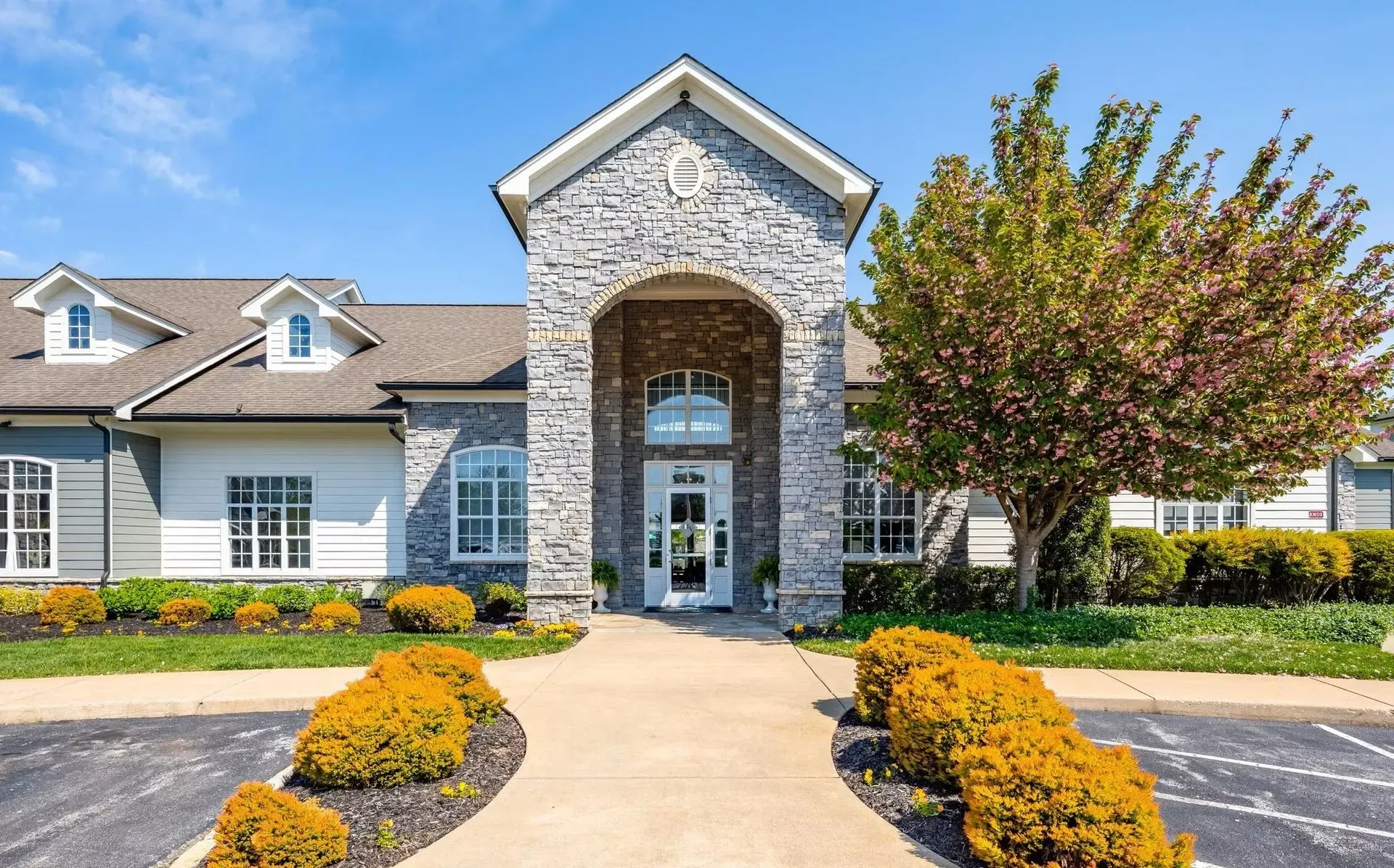 Exterior building entrance with stone facade and arched entryway.