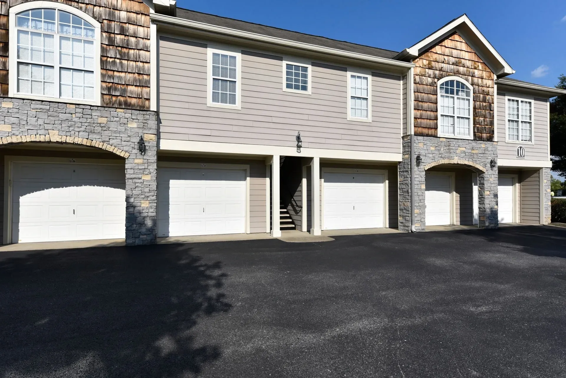 Exterior view of apartment building with garages.