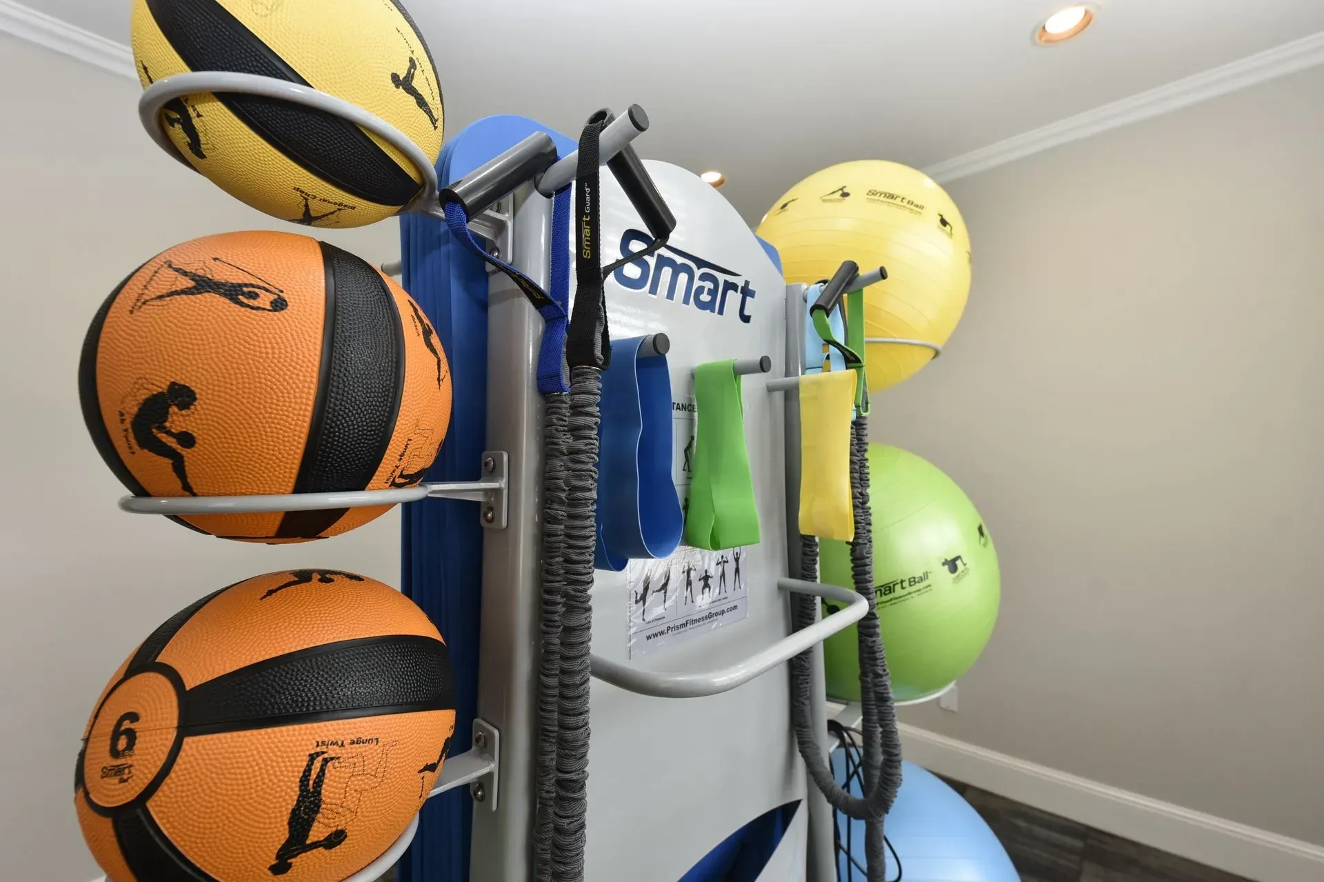 Workout equipment including medicine balls and resistance bands in a fitness center.
