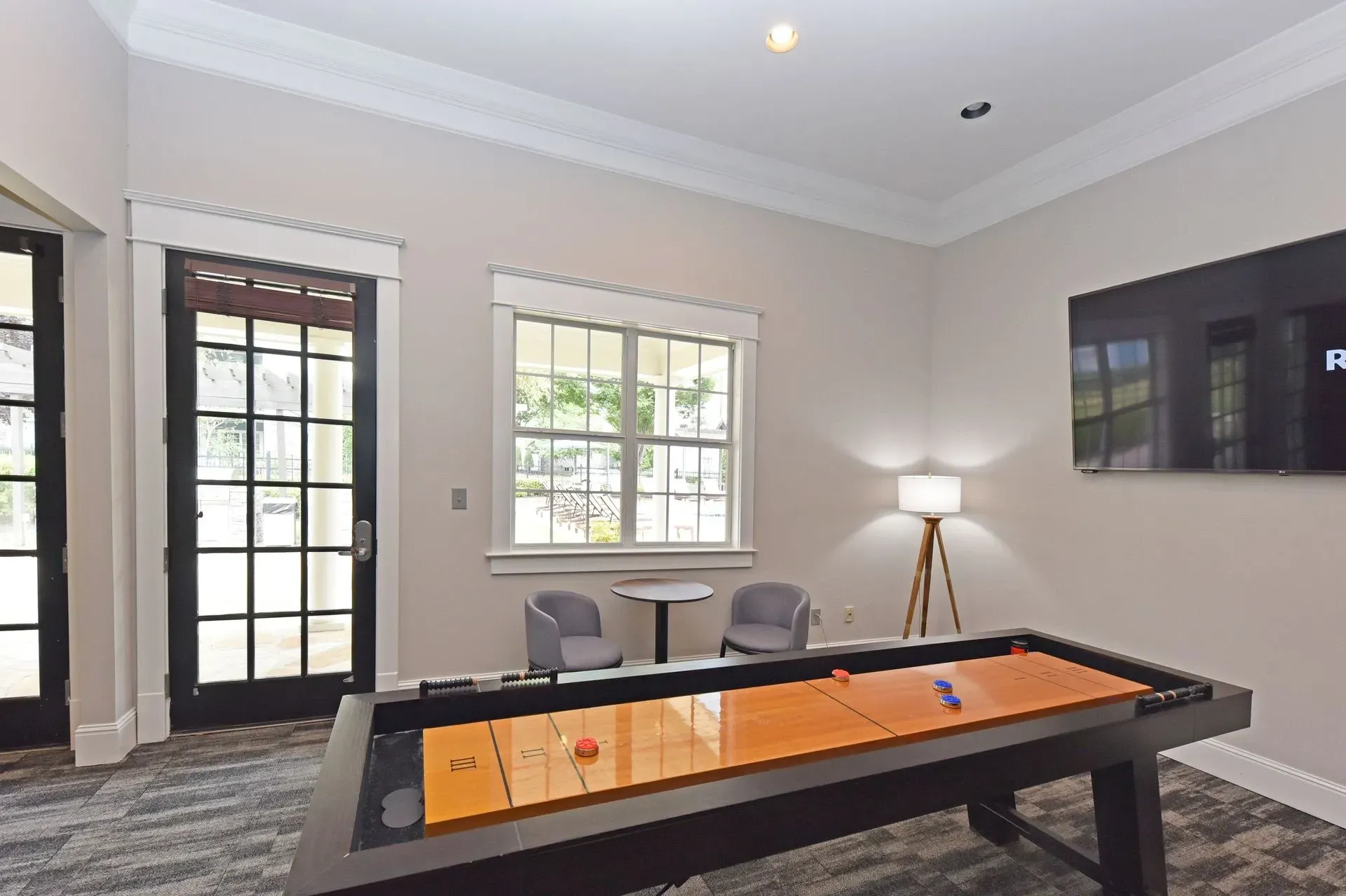 Shuffleboard table and seating area in community lounge