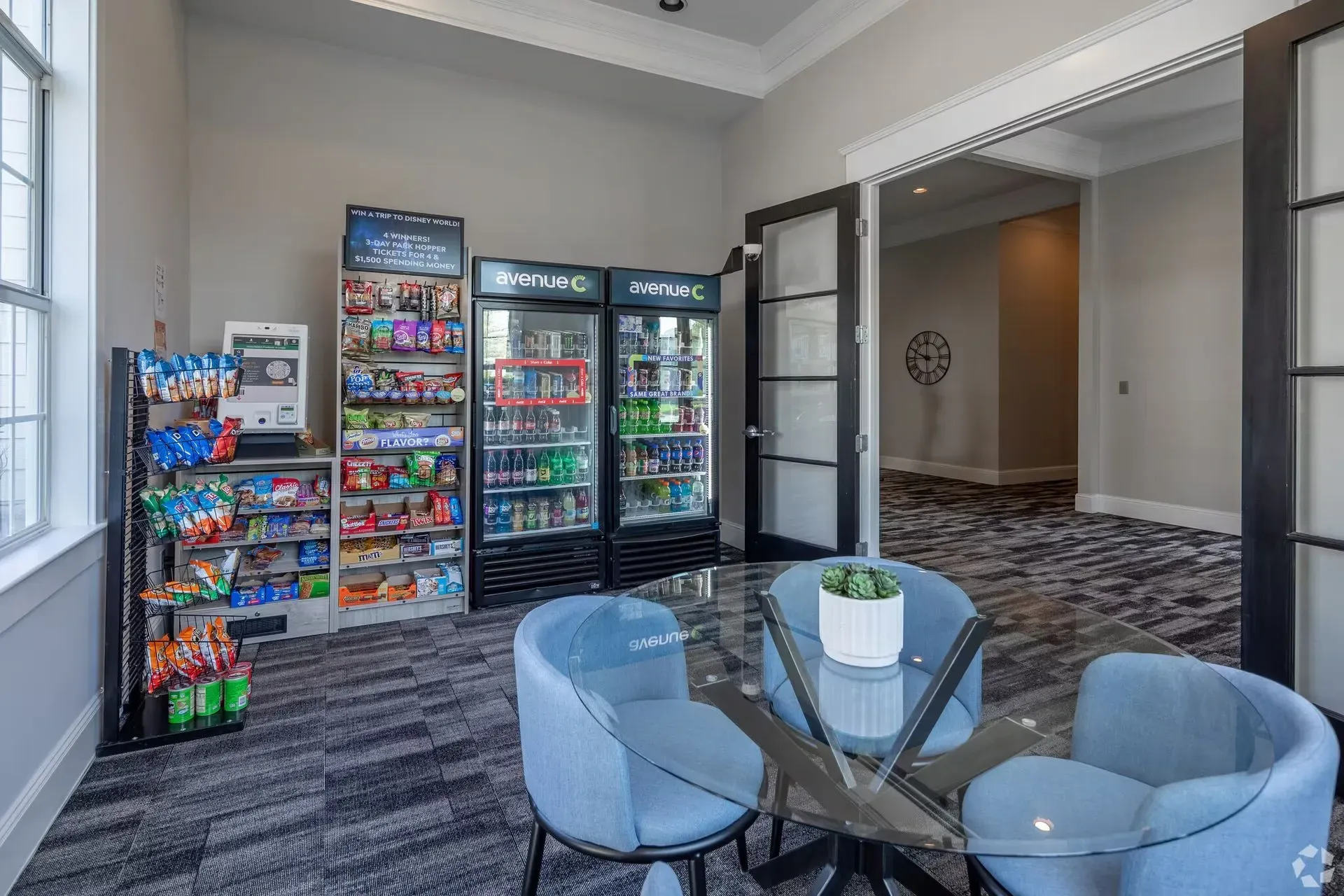 Convenience store with snacks and drinks, and a small seating area with a glass table.