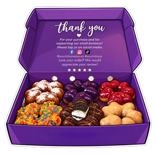 Assorted frosted donuts in a purple thank-you gift box with a printed message inside