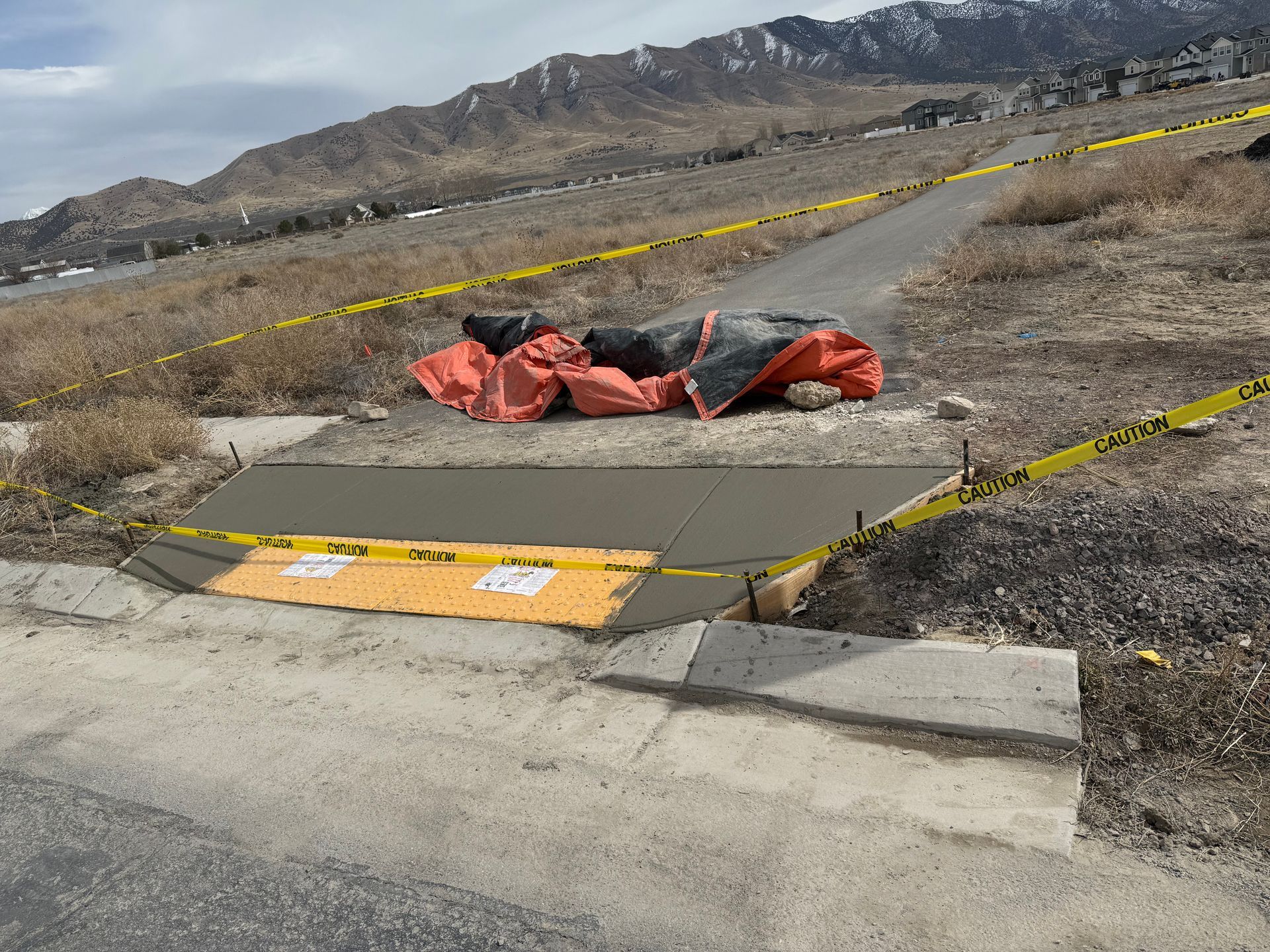 A concrete walkway is being built on the side of a road.