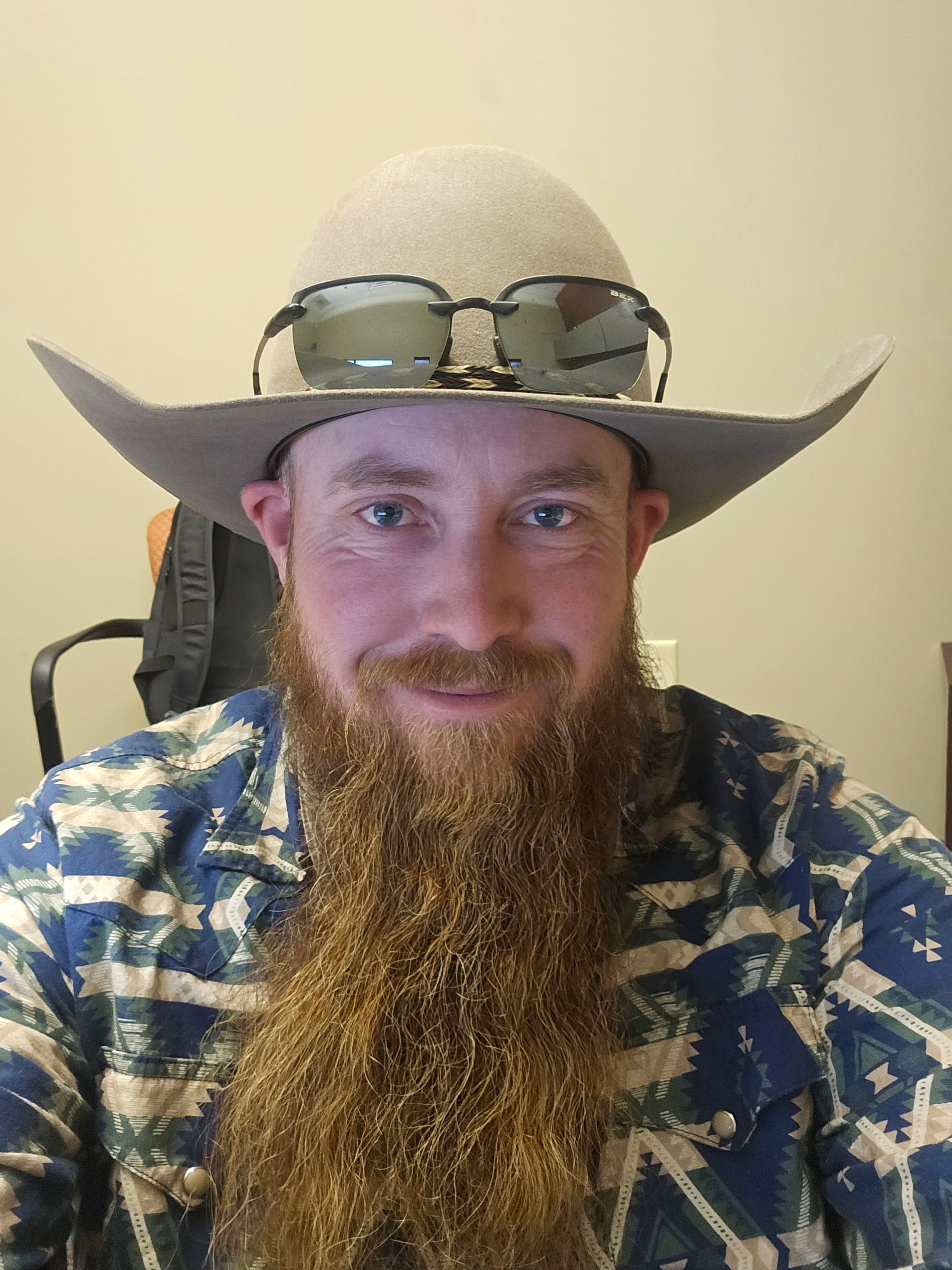 Jay shown with a long beard wearing a cowboy hat and sunglasses.