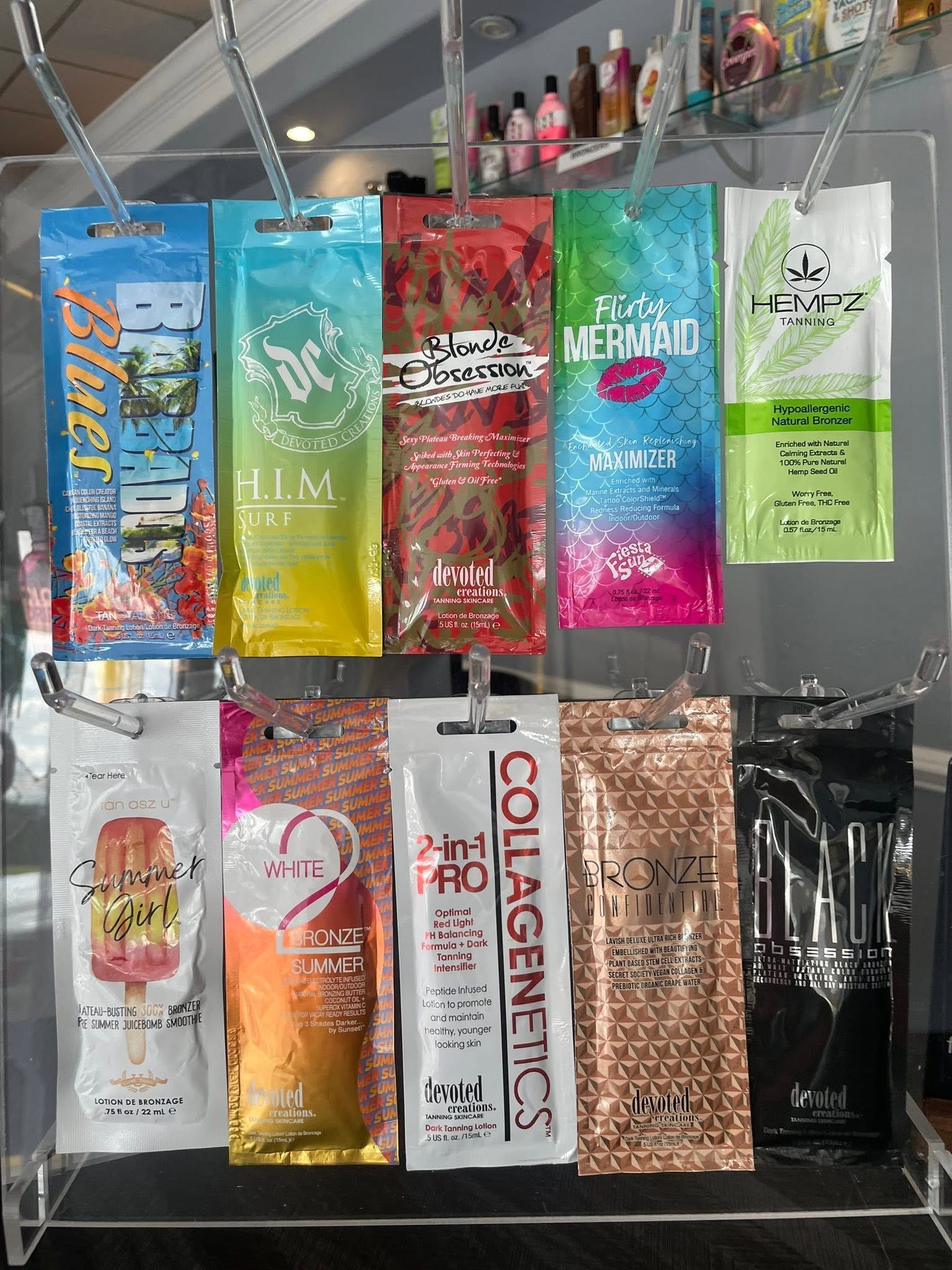 Assorted colorful hair care packets hanging on a store display rack