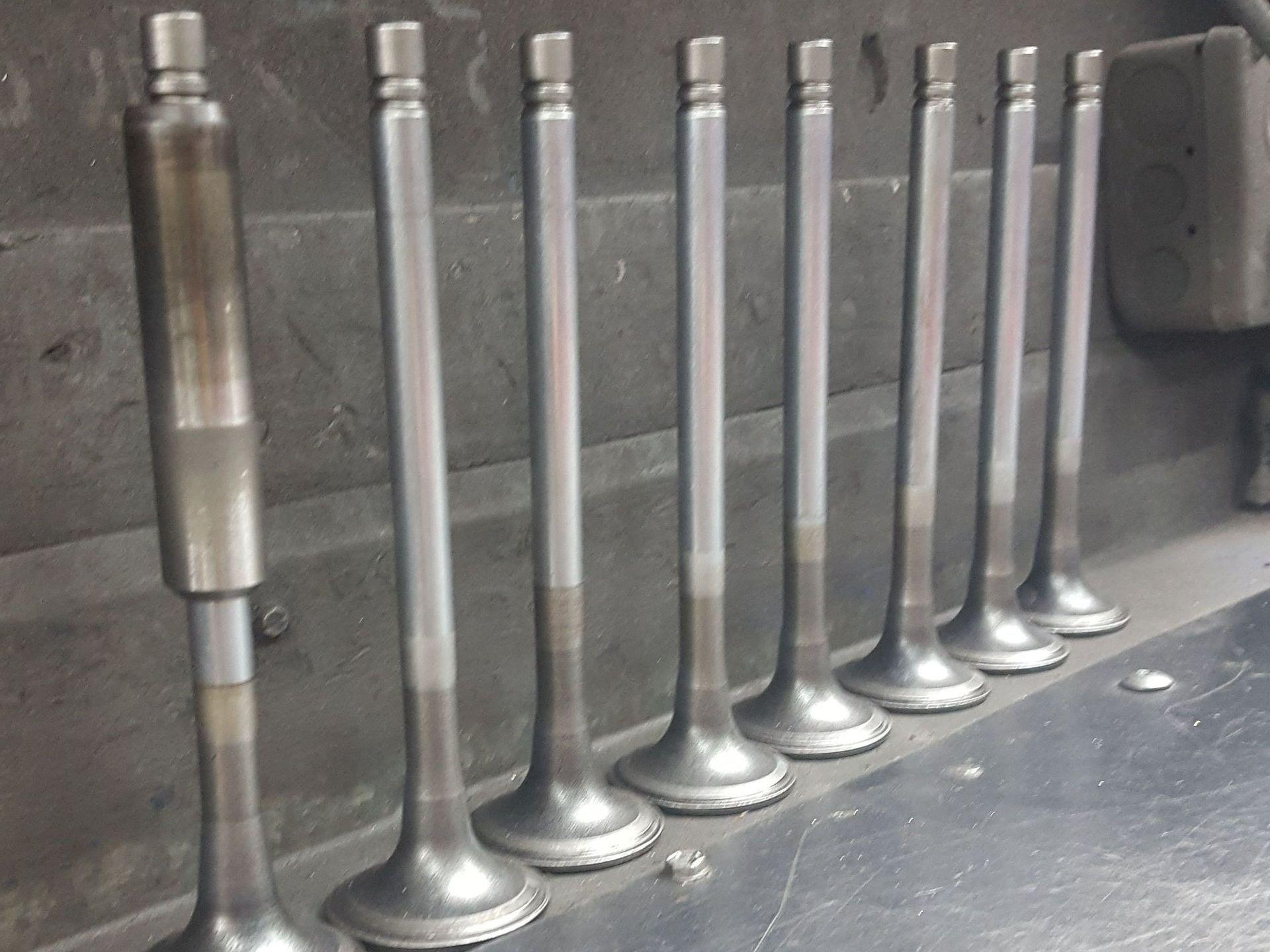 A row of metal valves are lined up in a row
