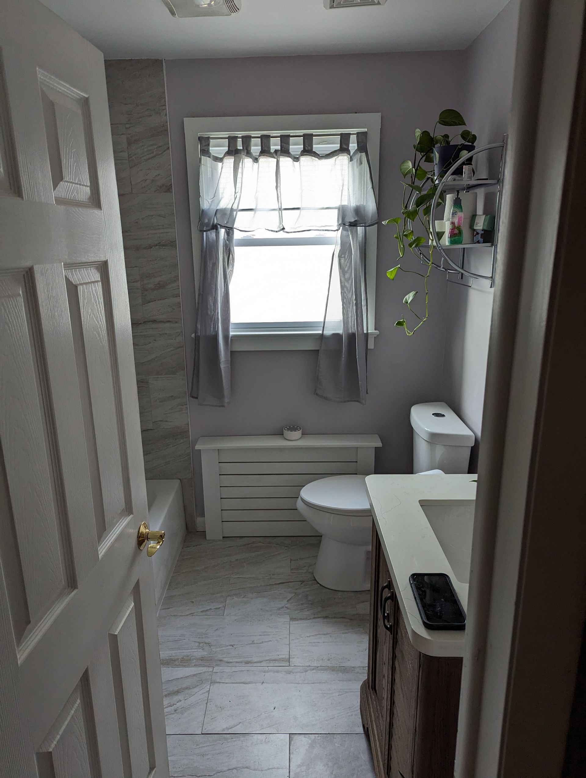 a bathroom with a toilet , sink , and window .