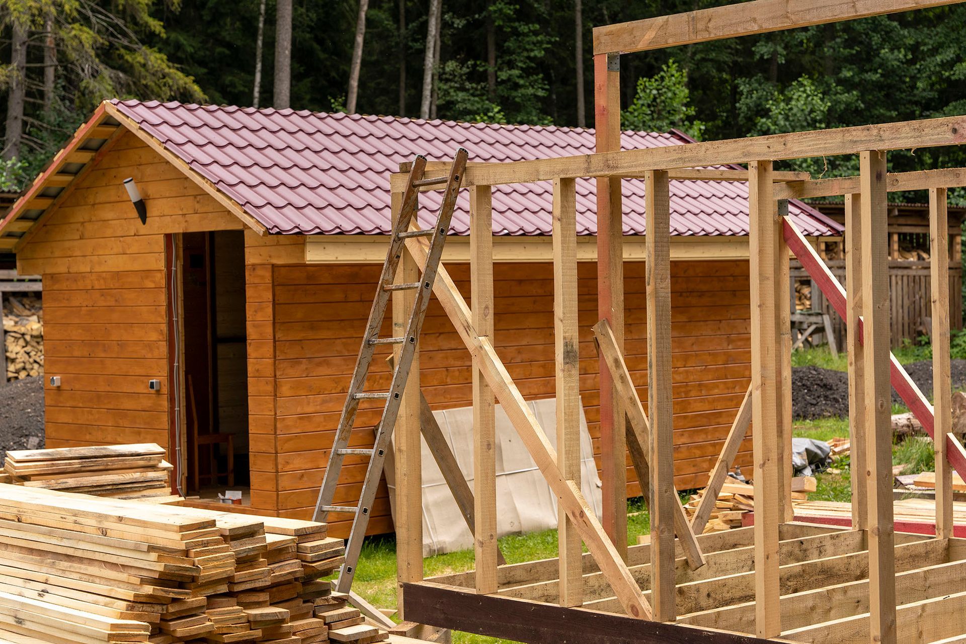 a house being built with wood and a ladder
