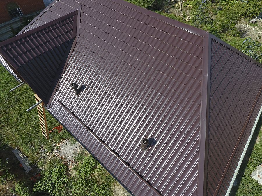 an aerial view of a house with a metal roof