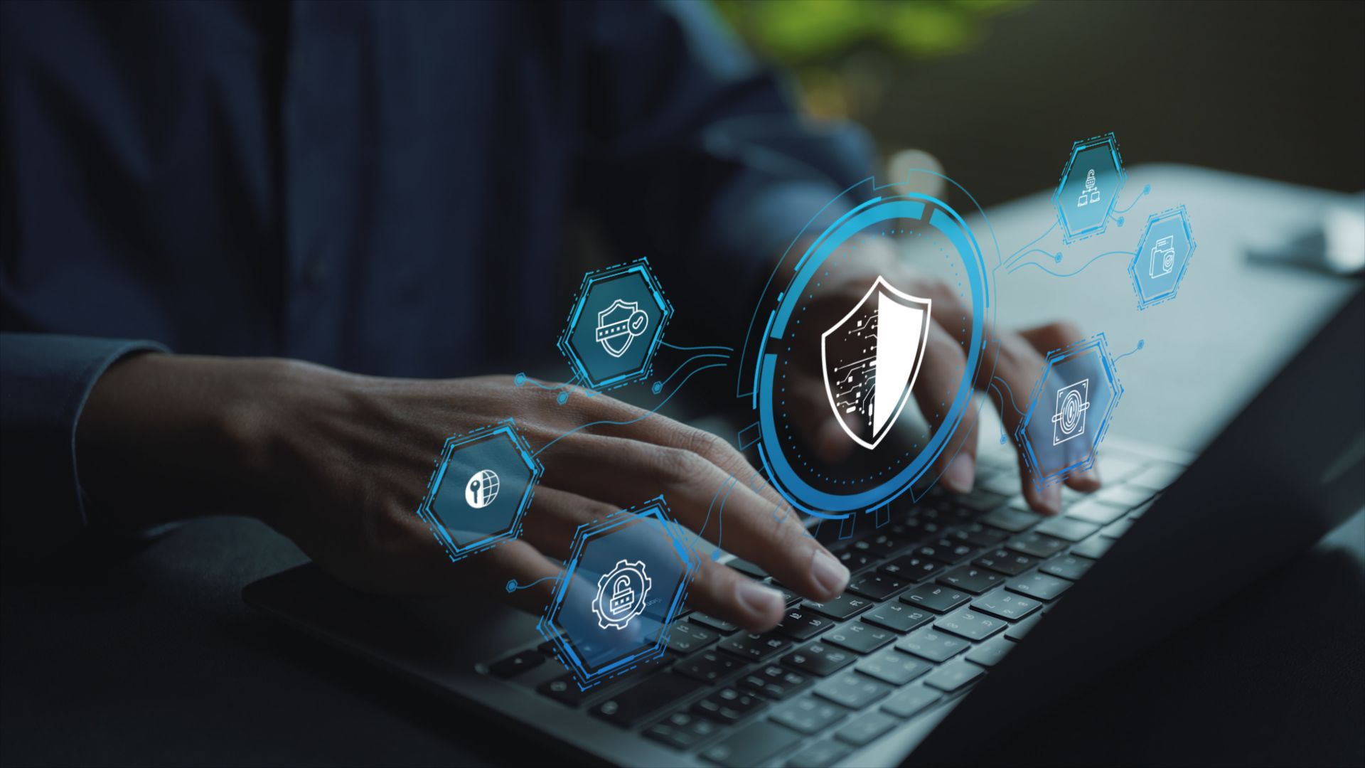 IT security company professional typing on a laptop with digital cybersecurity shield and data protection icons.