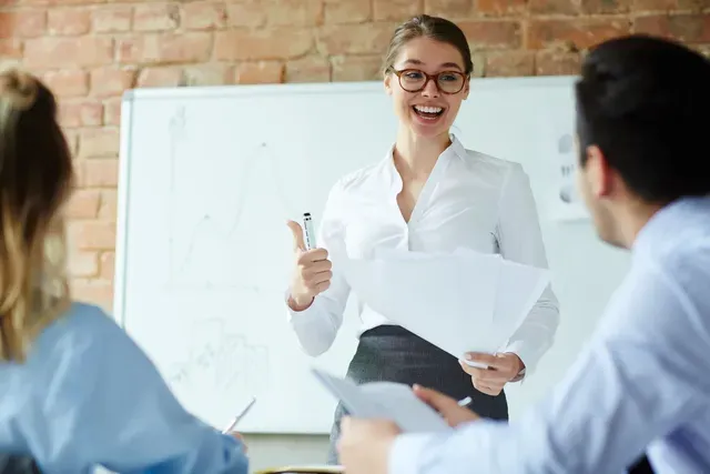 A woman is giving a presentation to a group of people.