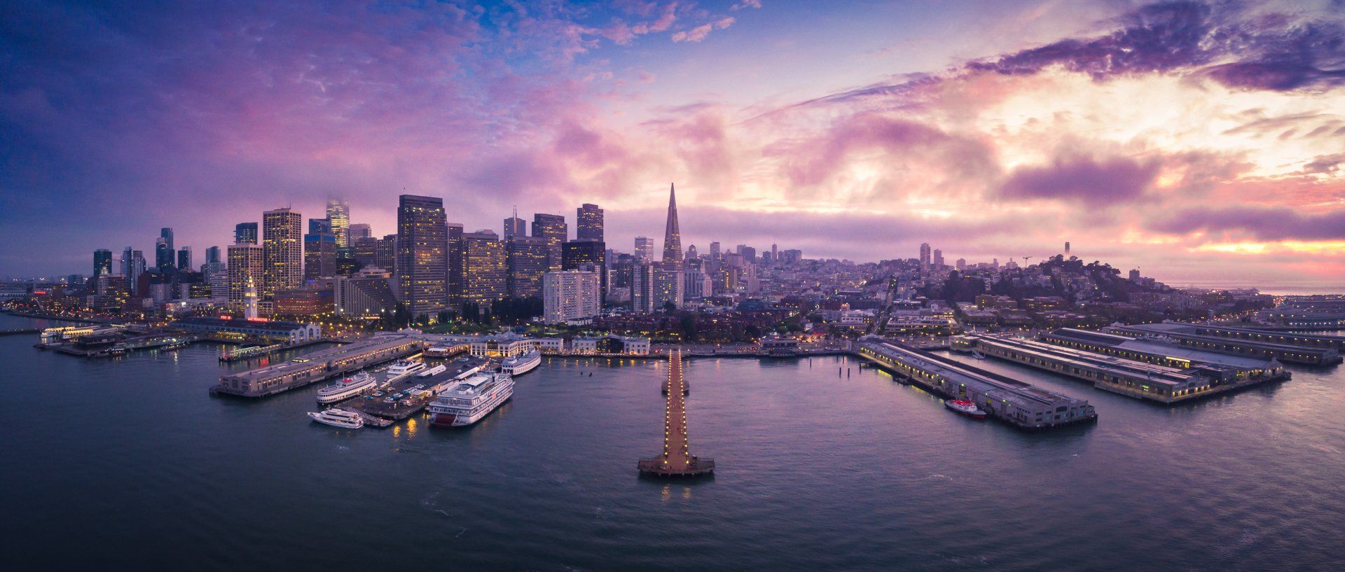 An aerial view of the san francisco skyline at sunset.