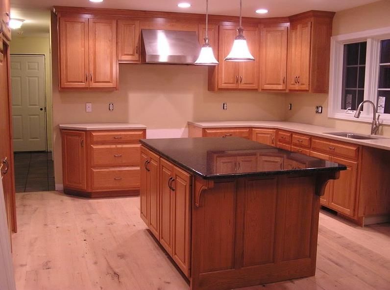 a kitchen with wooden cabinets and granite counter tops