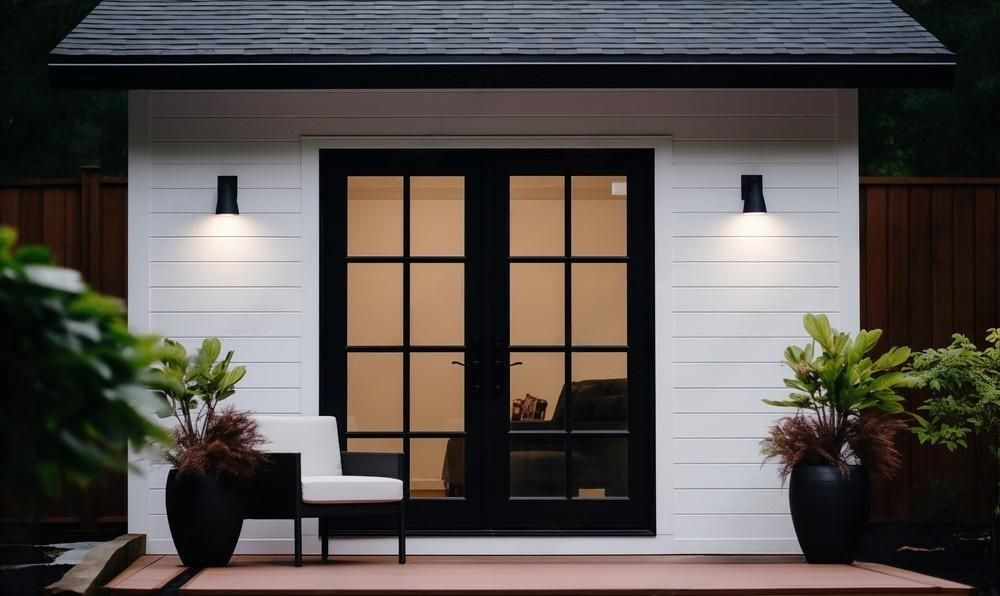 a white house with black sliding glass doors