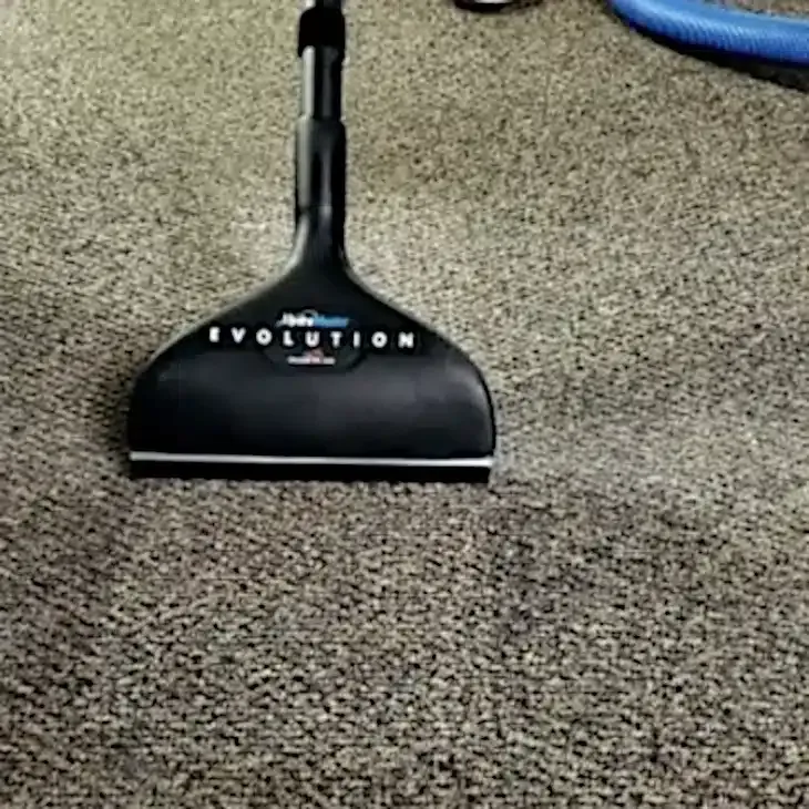 Black vacuum head on gray carpet. Black vacuum head on gray carpet.