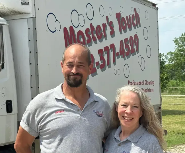Two people standing in front of a truck, logo reads Two people standing in front of a truck, logo reads