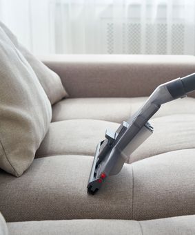 Young Housewife Cleaning Sofa — Cairns, QLD — Big Red Carpet Shampooing Young Housewife Cleaning Sofa — Cairns, QLD — Big Red Carpet Shampooing