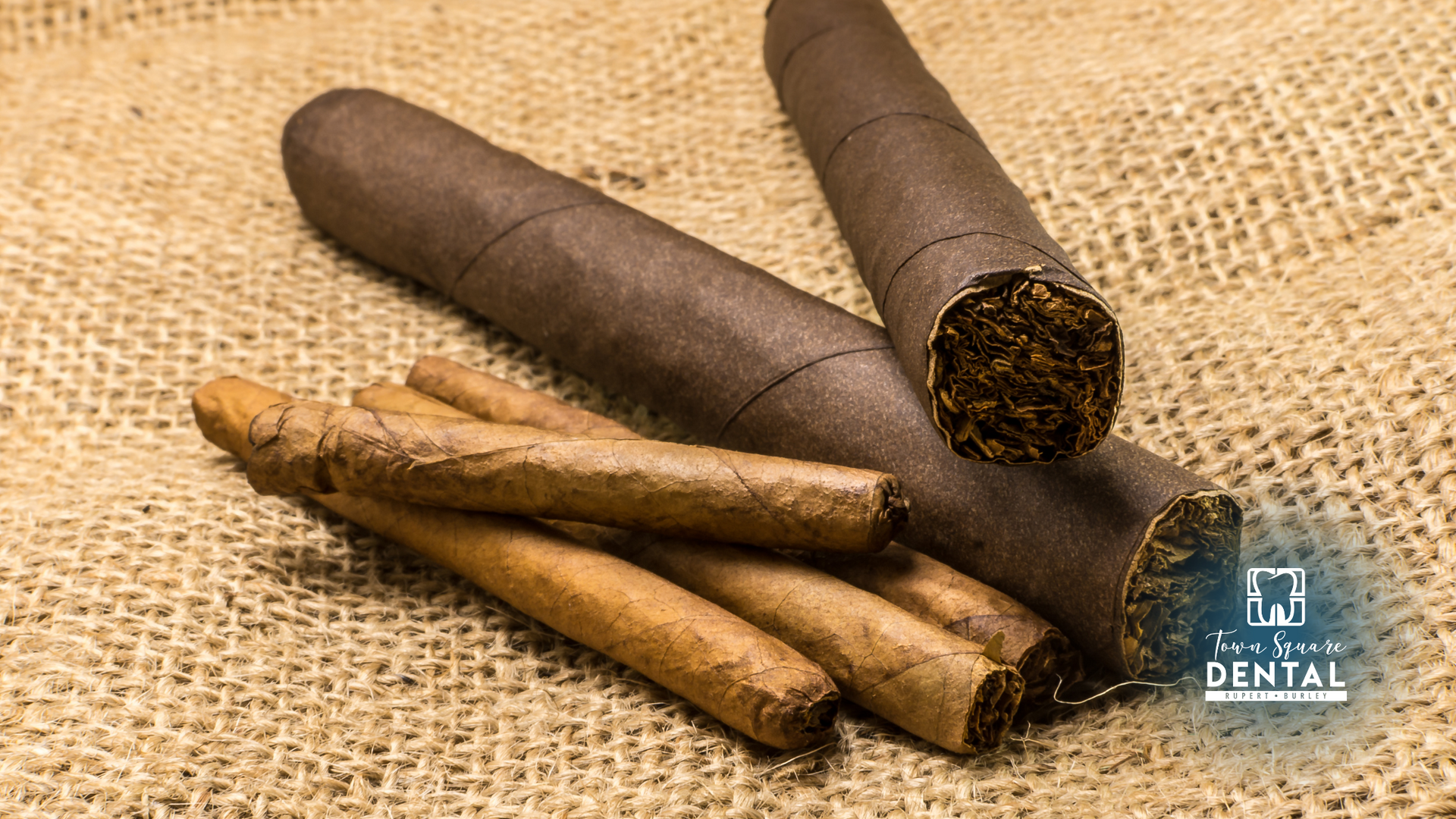A group of cigars sitting on top of each other on a table.