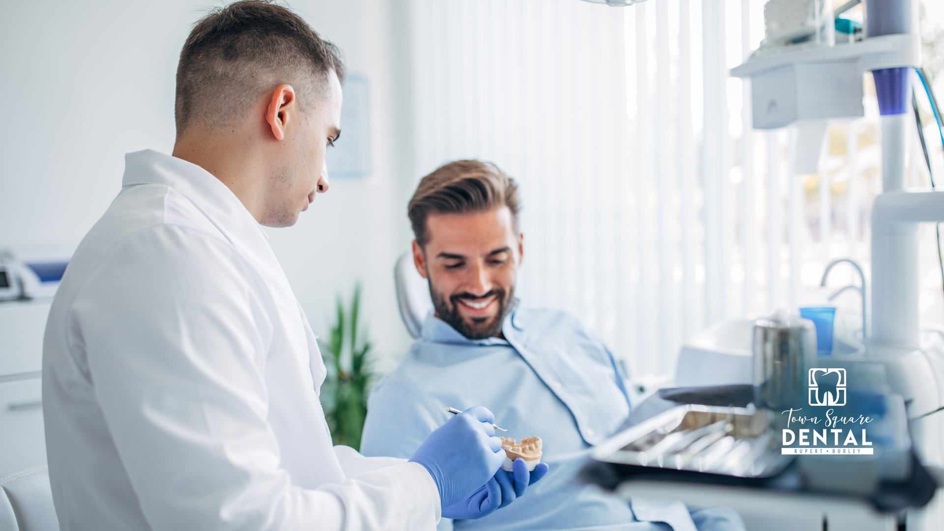 Dentist and patient smiling in a bright clinic during a dental exam