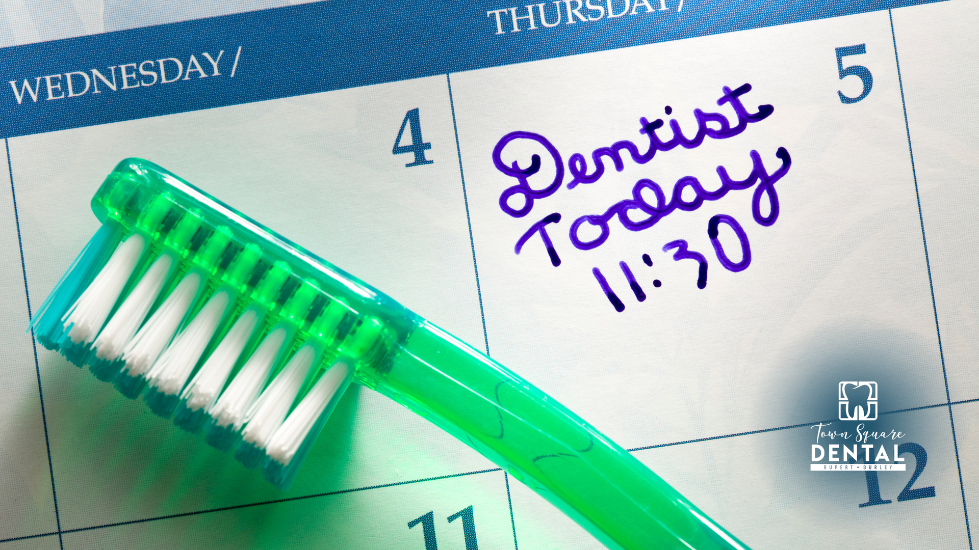 A green toothbrush is sitting on top of a calendar that says dentist today
