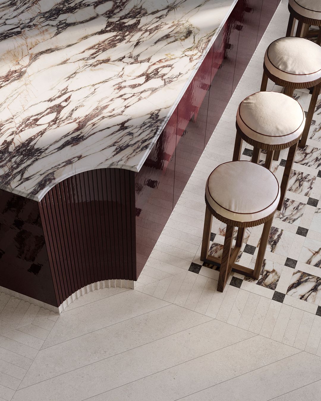 Marble countertop and stools in a luxury setting. Burgundy details, patterned floor.