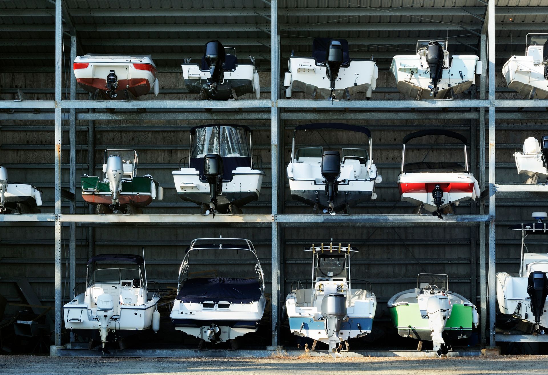 A row of boats are lined up against a wall