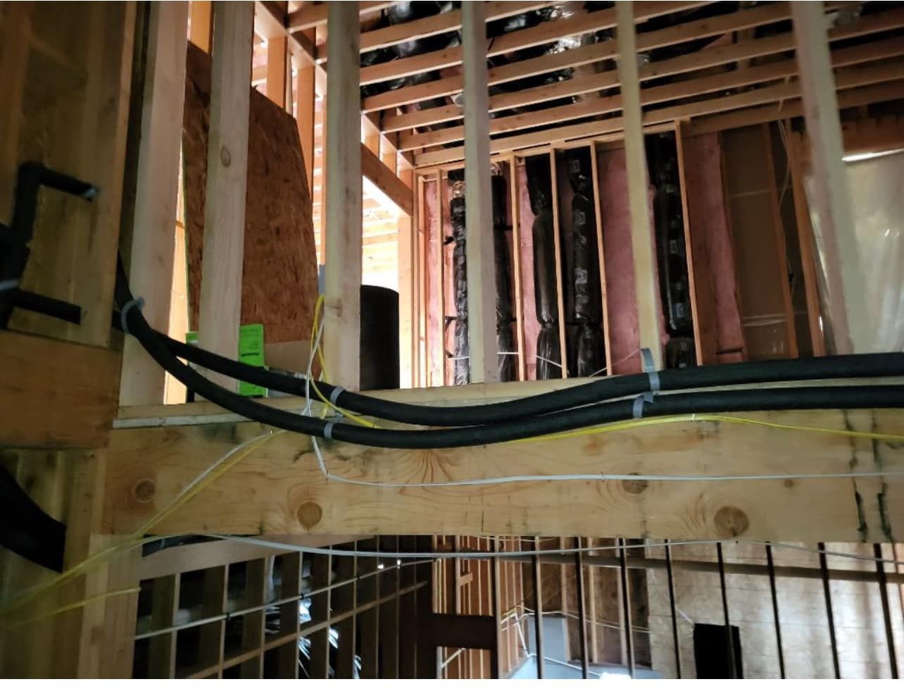 A bunch of wires are hanging from the ceiling of a building