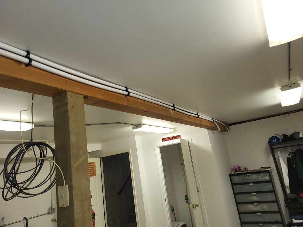 A room with a lot of wires hanging from the ceiling