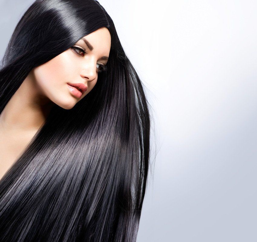 A woman with very long black hair is looking down