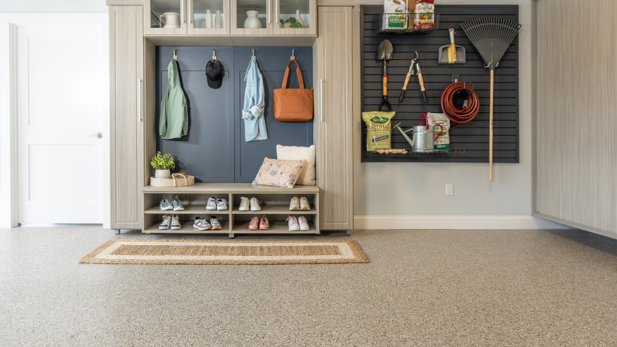 Modern entryway with grey tile floors, wooden accents, and a blue cabinet with plants.