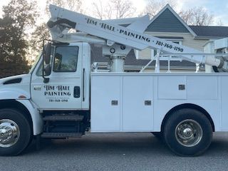 A white utility truck is parked in front of a house.
