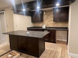 A kitchen with a large island in the middle of it.