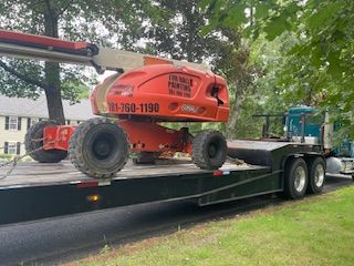 A crane is sitting on top of a trailer.