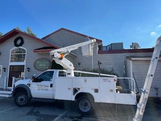 A person is painting a house with a paint roller.