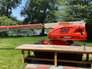 A red crane is sitting on top of a wooden table.