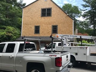 A white truck is parked in front of a house.