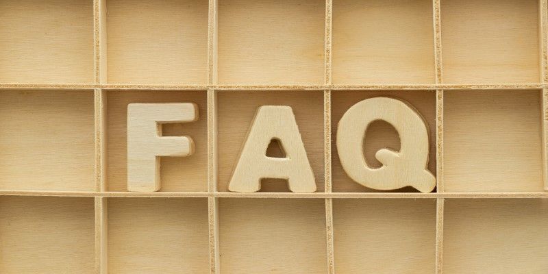 The word faq is written in wooden letters in a wooden box.